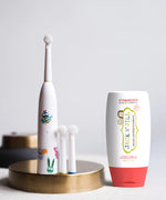 Jack N' Jill Fluoride-Free Strawberry Toothpaste 200g pictured next to buzzy brush toothbrush.