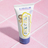 The Jack N Jill kids natural toothpaste in a bubblegum flavour, on pale pink tiles.
