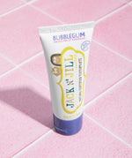 The Jack N Jill kids natural toothpaste in a bubblegum flavour, on pale pink tiles.