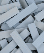 A pile of grey coloured Kapla planks.