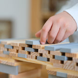 A build created using natural and grey coloured Kapla wooden planks.