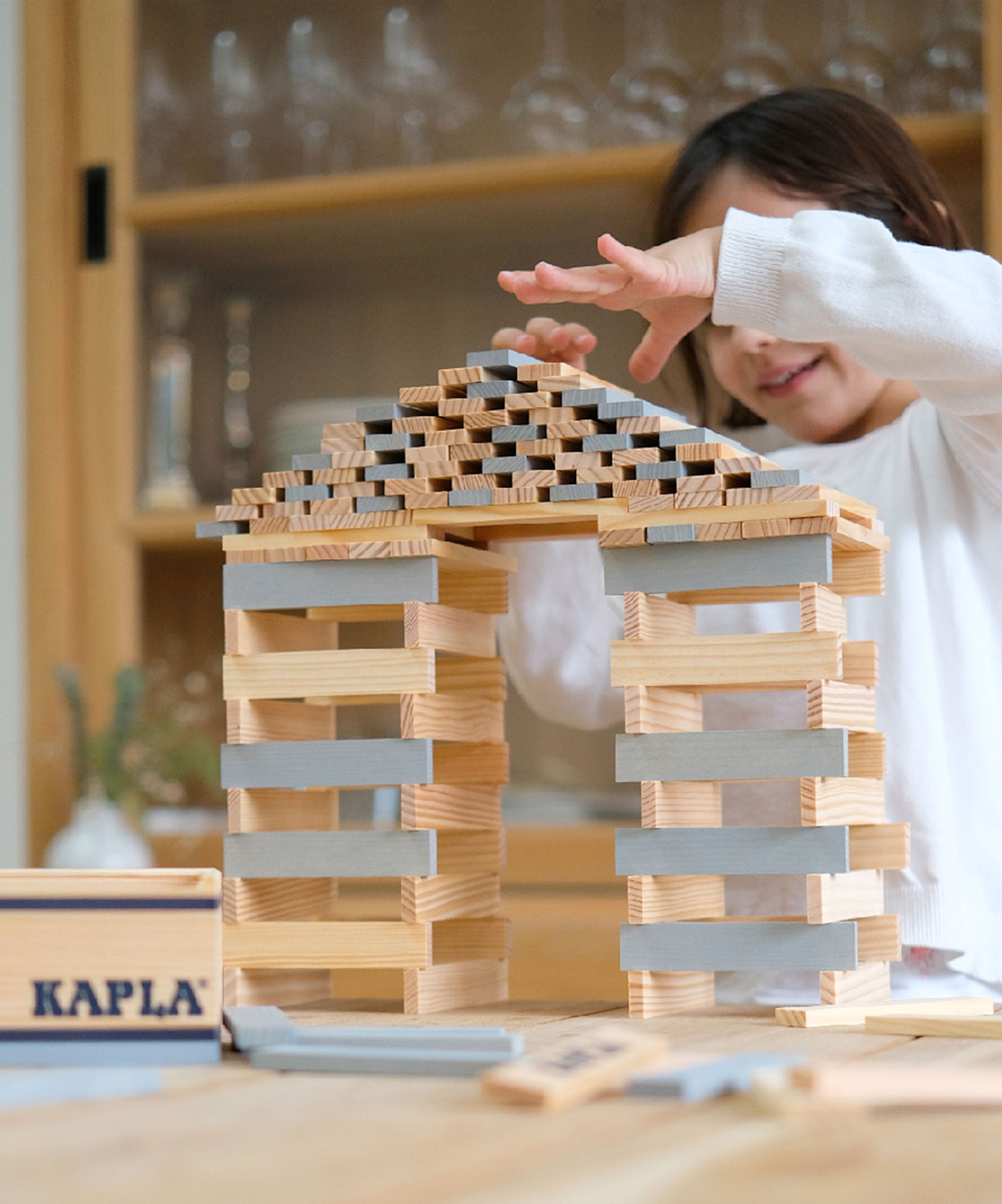 A build created using natural and grey coloured Kapla wooden planks.