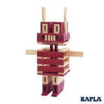 Kapla plastic-free wooden construction shapes stacked into a robot shape on a white background