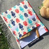 A close up of the organic cotton robot Keep Leaf large baggie outside on a blanket opened with food inside