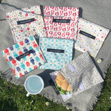 A group of Keep Leaf large baggies outside on a grey blanket showing the mesh, geo, robot, stars, new fruit and bloom designs