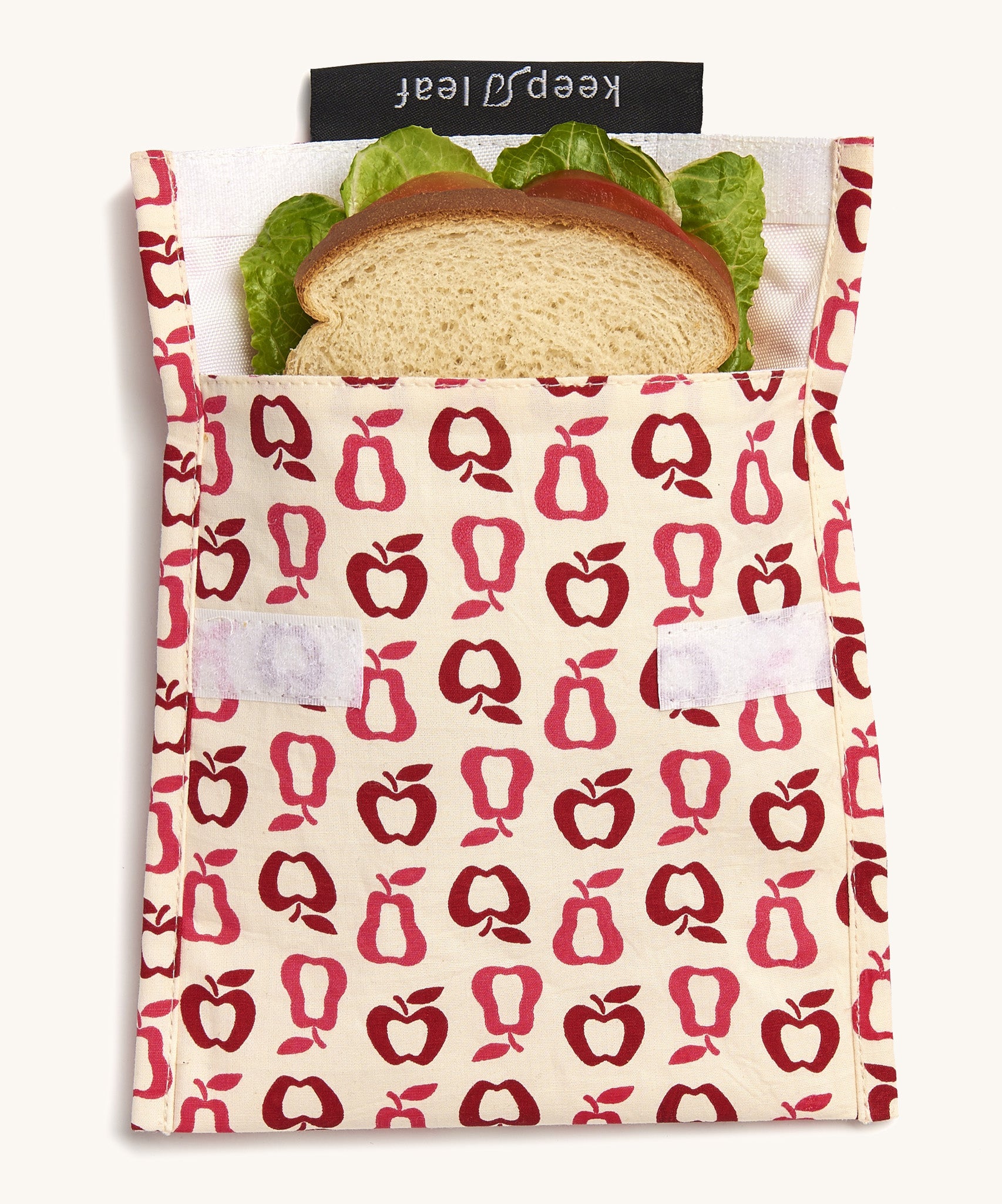 Keep Leaf large baggie in new fruit design. A cream colour organic cotton pouch for food with red apples and pears outline printed all over. Features a velcro lid for easy fastening and a sandwich inside for size reference