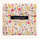 Keep Leaf large baggie in bloom design. A cream colour organic cotton pouch for food with cute flowers printed all over. Features a velcro lid for easy fastening