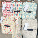 A group of Keep Leaf insulated lunchbags on a concrete step. Features a new fruit, robot, geo, bloom, stars and mesh designs