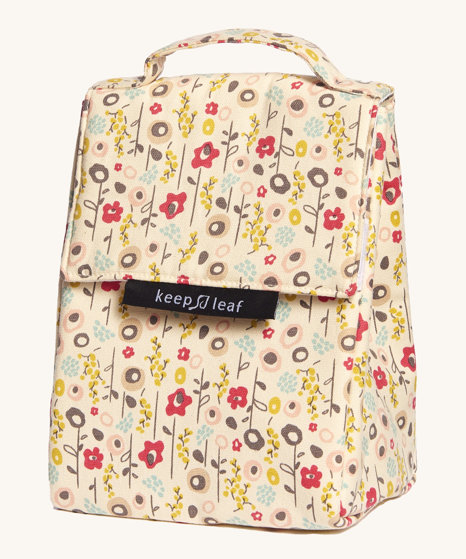 Keep Leaf insulated lunchbag in bloom design. A cream colour organic cotton bag  with light cute flowers printed all over. Features a handle for carrying and a velcro lid.