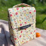 Keep Leaf insulated lunchbag in bloom design on a blanket in the garden