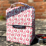 Keep Leaf insulated lunchbag in new fruit design on a concrete step next a tin with tomatoes