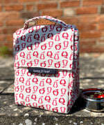 Keep Leaf insulated lunchbag in new fruit design on a concrete step next a tin with tomatoes