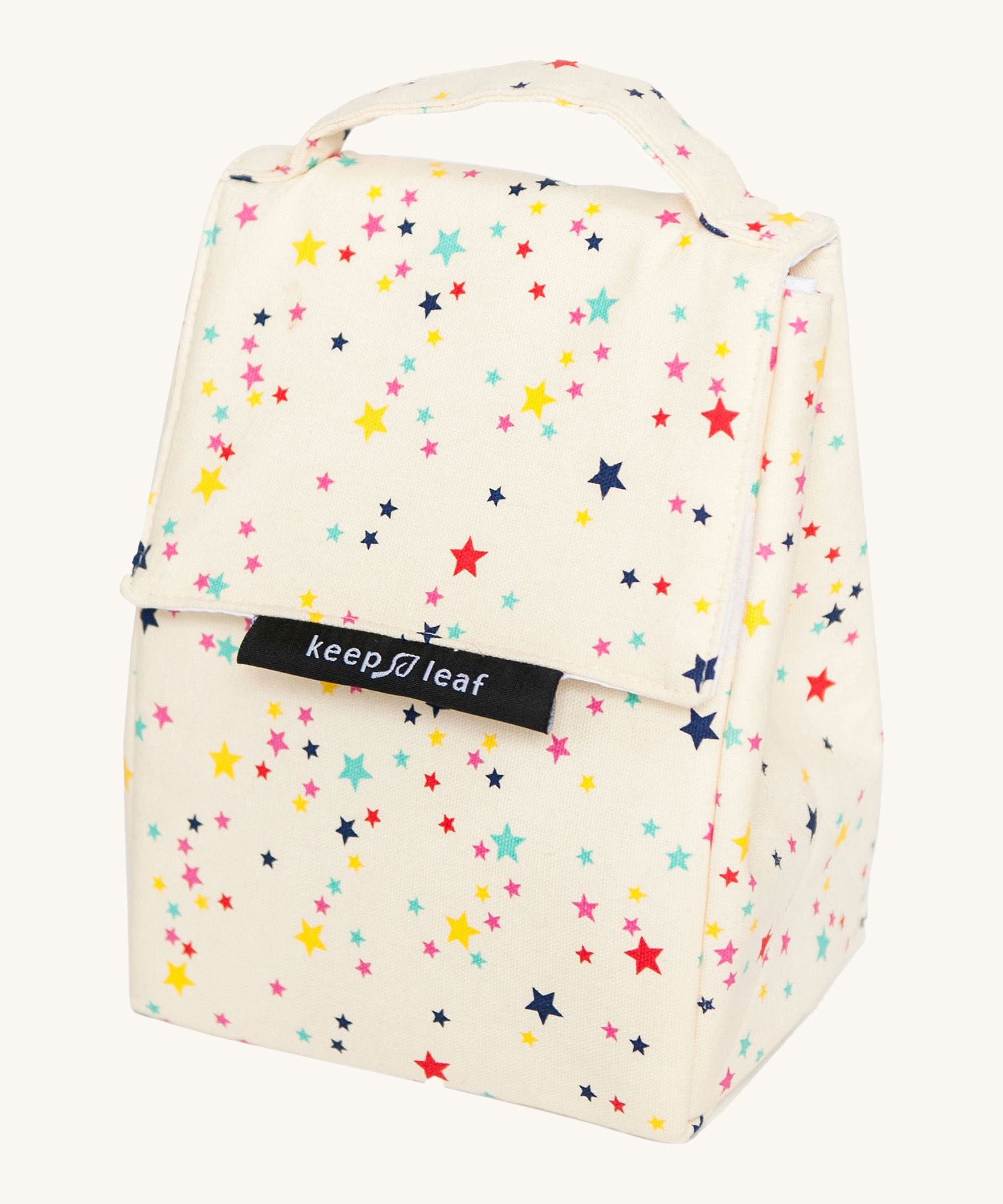 Keep Leaf insulated lunchbag in stars design. A cream colour organic cotton bag  with multicoloured stars printed all over. Features a handle for carrying and a velcro lid.