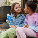 Two children sitting on a step outdoors, one child is holding a Rainbow print Kid Kanteen 12oz Insulated Flip Seal Sport Cap Bottle.