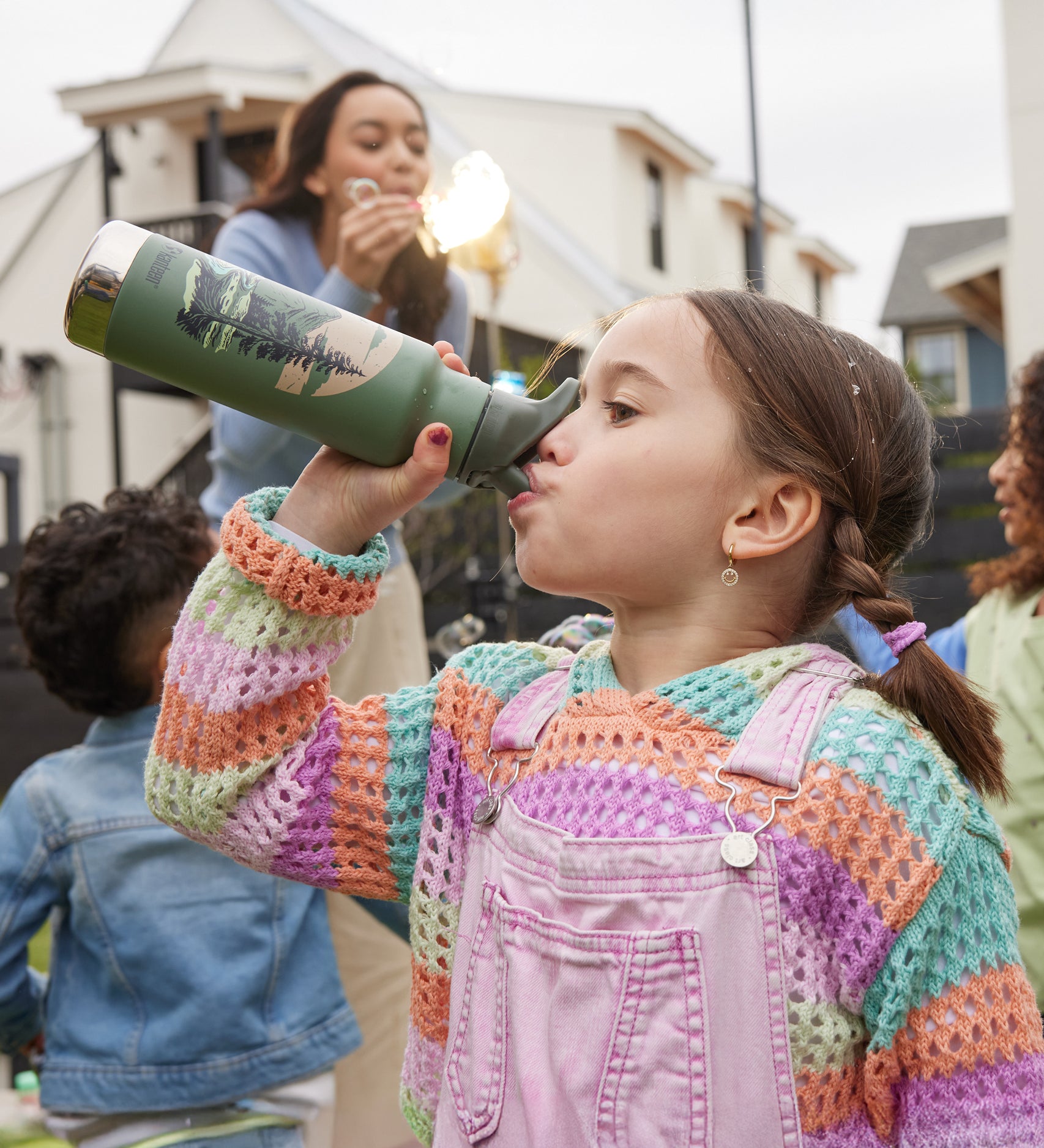 A child drinking from a Mountain Scape print Kid Kanteen 12oz Insulated Flip Seal Sport Cap Bottle.