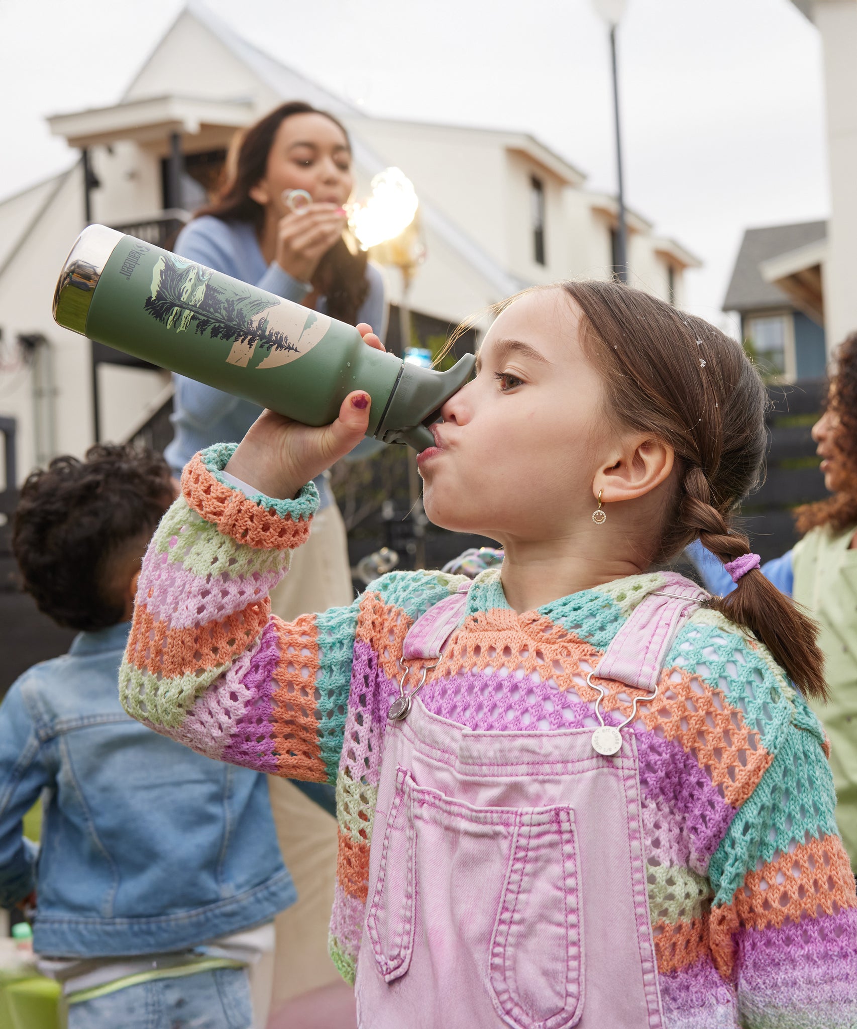 A child drinking from a Mountain Scape print Kid Kanteen 12oz Insulated Flip Seal Sport Cap Bottle.
