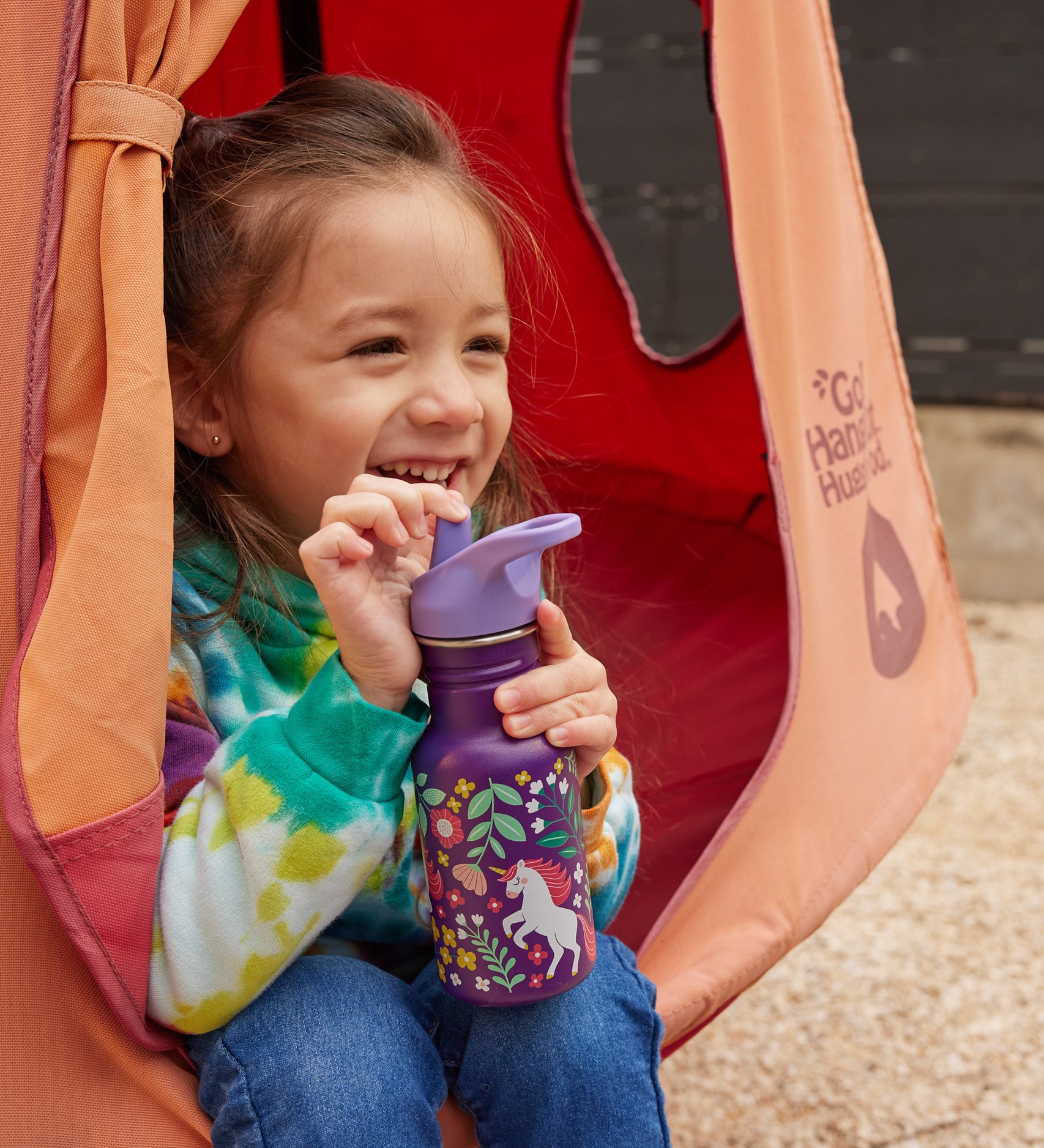 A child drinking from a purple coloured Leaping Unicorns print Kid Kanteen 12oz Narrow Flip Seal Sport Cap Bottle.