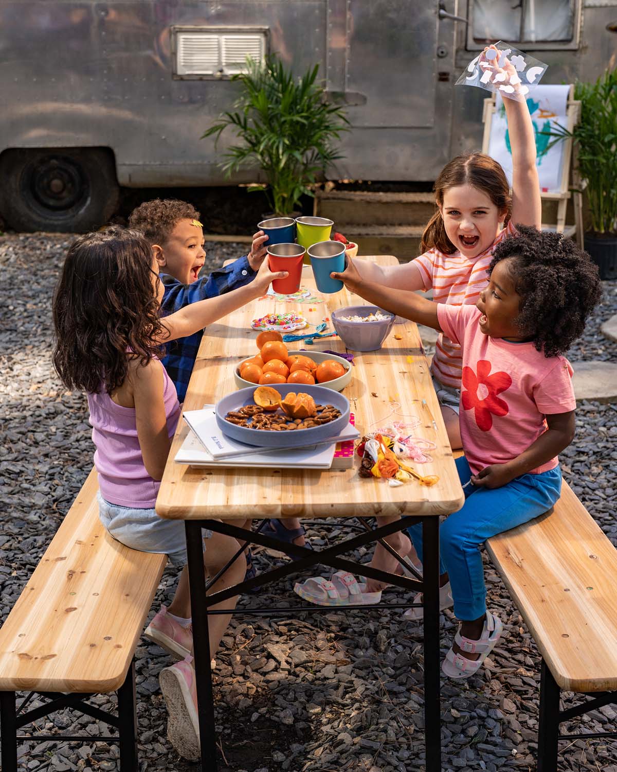Kids clinking their stainless steel Klean Kanteen kids cups - plastic free durable 10oz tumblers in fun bright colours - for sale at Babipur.