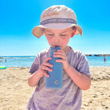 A child enjoying a day out on the beach in the sun