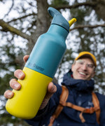 A man holding the Brittany 16oz stainless steel reusable klean kanteen insulated rise bottles showing the colour way design detail