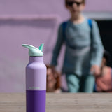 A close up of the orchid kaleidoscope 16oz Klean Kanteen stainless steel reusable rise bottle showing the purple colourway design and turquoise cap detail