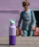 A close up of the orchid kaleidoscope 16oz Klean Kanteen stainless steel reusable rise bottle showing the purple colourway design and turquoise cap detail