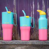 Klean Kanteen turquoise kaleidoscope 16oz, 26oz and 36oz rise insulated stainless steel bottle and tumblers on a stone surface showing the pink and turquoise colour way design and handle detail on the tumblers