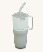 Klean Kanteen 26oz barely blue rise insulated stainless steel tumbler available at Babipur. A pale blue and grey with a matching flip lid. Features a handle on the side and matching straw.