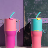 A Klean Kanteen 26oz klean kanteen stainless steel rise insulated tumbler standing on a stone surface next to a 26oz turquoise rise tumbler.