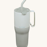 Klean Kanteen 36oz barely blue rise insulated stainless steel tumbler available at Babipur. A pale blue and grey with a matching flip lid. Features a handle on the side and matching straw.