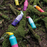 A group of the new Klean Kanteen rise collection available at Babipur on woodland ground showing the acacia, pink lemonade classic bottles and the marigold, orchid, bay and turquoise kaleidoscope 16oz stainless steel reusable bottles