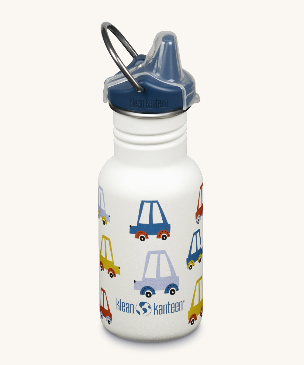 A Kid Kanteen 12oz Narrow Sippy reusable stainless steel water Bottle. The bottle is white with a multi coloured car print, the sippy lid is navy blue.