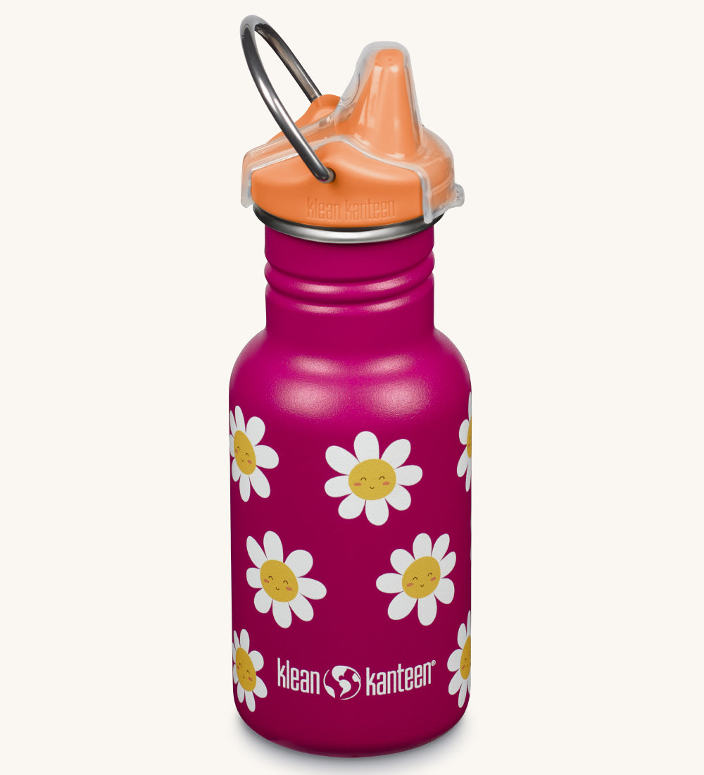 A Kid Kanteen 12oz Narrow Sippy reusable stainless steel water Bottle. The bottle is deep pink with a cute happy daisies flower print, the sippy lid is orange.