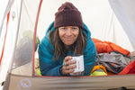 An adult enjoying a drink from their Klean Kanteen 12oz Insulated Camping Mug in White