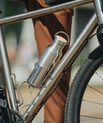 A klean Kanteen 16oz reflect stainless steel Klean Kanteen insulated bottle in bottle holder on a bike.