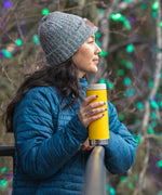 A person holding a Klean Kanteen 16oz TKWide in aSunset yellow colour with taupe Cafe cap.