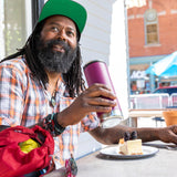 Man sat at a bench holding a Klean Kanteen eco-friendly stainless steel drinks bottle