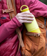 A close up of a adult hand holding on the acacia 20oz Klean Kanteen rise water bottle showing the matching loop cap detail.