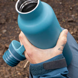 A adult hand holding the Brittany blue 20oz Klean Kanteen Reusable Stainless Steel Water Bottle with the loop cap off and showing the inside thread detail