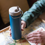 A close up of a person's hand holding a cosair blue coloured Klean Kanteen 20oz TKWide .