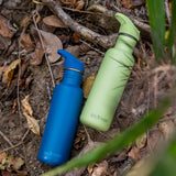 Two corsair blue and shadow lime coloured Klean Kanteen 27oz Classic Narrow Leakproof Flip Seal Sports Cap Reusable Stainless Steel Water Bottle laying on the ground.