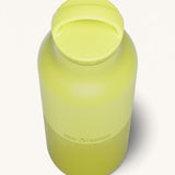 A close up of the Klean Kanteen 20oz Classic rise acacia insulated classic reusable steel water bottle showing the handle detail on the yellow loop cap