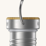 A close up of the Klean Kanteen bamboo stainless steel loop cap for the rise reflect insulated bottles showing the handle and thread detail