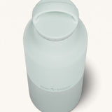 A close up of the Klean Kanteen 20oz Classic rise barely blue insulated classic reusable steel water bottle showing the handle detail on the pale blue loop cap