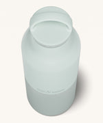 A close up of the Klean Kanteen 20oz Classic rise barely blue insulated classic reusable steel water bottle showing the handle detail on the pale blue loop cap