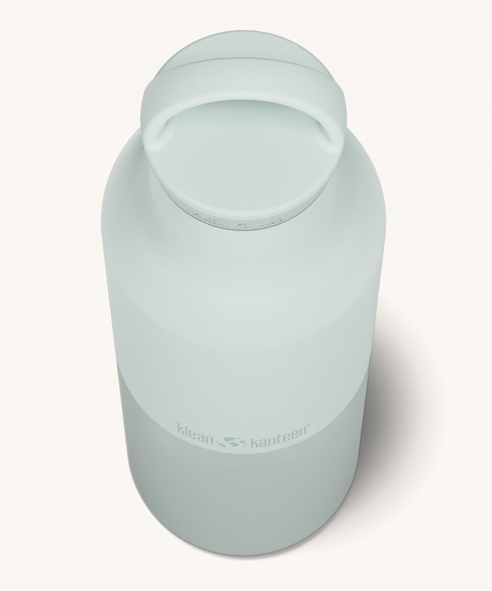 A close up of the Klean Kanteen 20oz Classic rise barely blue insulated classic reusable steel water bottle showing the handle detail on the pale blue loop cap