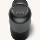 A close up of the Klean Kanteen 20oz Classic rise black insulated classic reusable steel water bottle showing the handle detail on the loop cap
