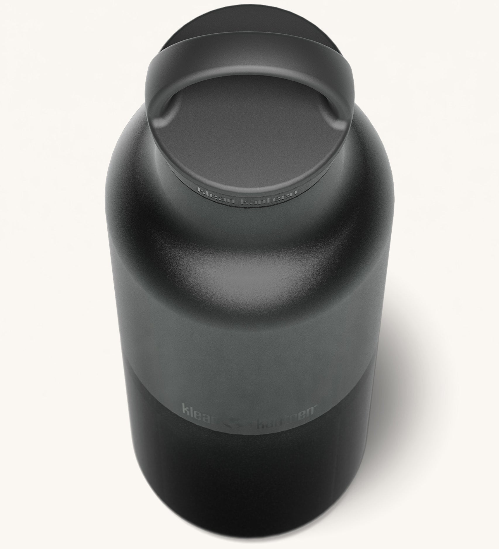 A close up of the Klean Kanteen 20oz Classic rise black insulated classic reusable steel water bottle showing the handle detail on the loop cap