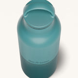 A close up of the Klean Kanteen 20oz Classic rise Brittany blue insulated classic reusable steel water bottle showing the handle detail on the dark blue loop cap