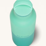 A close up of the Klean Kanteen 20oz Classic rise cabbage insulated classic reusable steel water bottle showing the handle detail on the light green loop cap